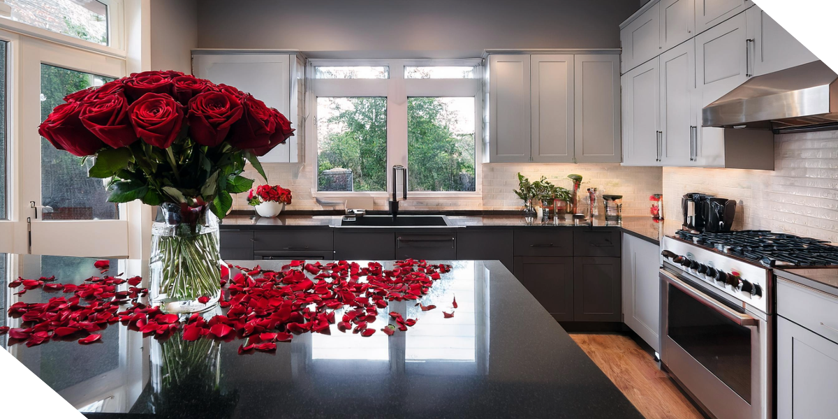 Modern kitchen remodel with sleek countertops, updated cabinetry, and a bouquet of red roses for a stylish finish.